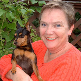 Gudrun Cobb, owner of Uncommon Paws poses with her favorite canine companion Baxter.